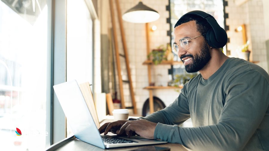 A specialist with a headset working on a laptop